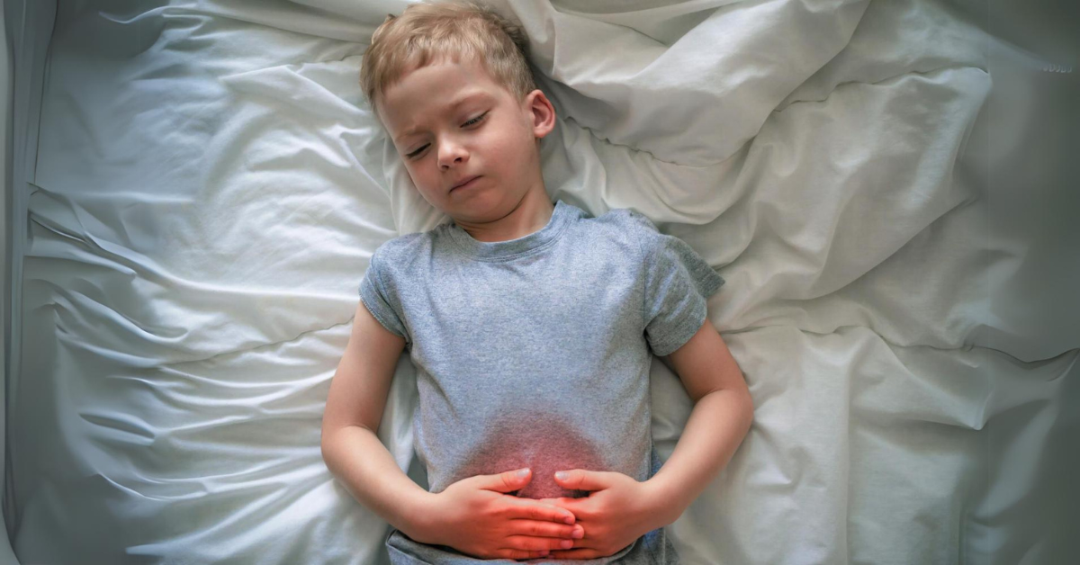 dečak se drži za stomak jer ga boli