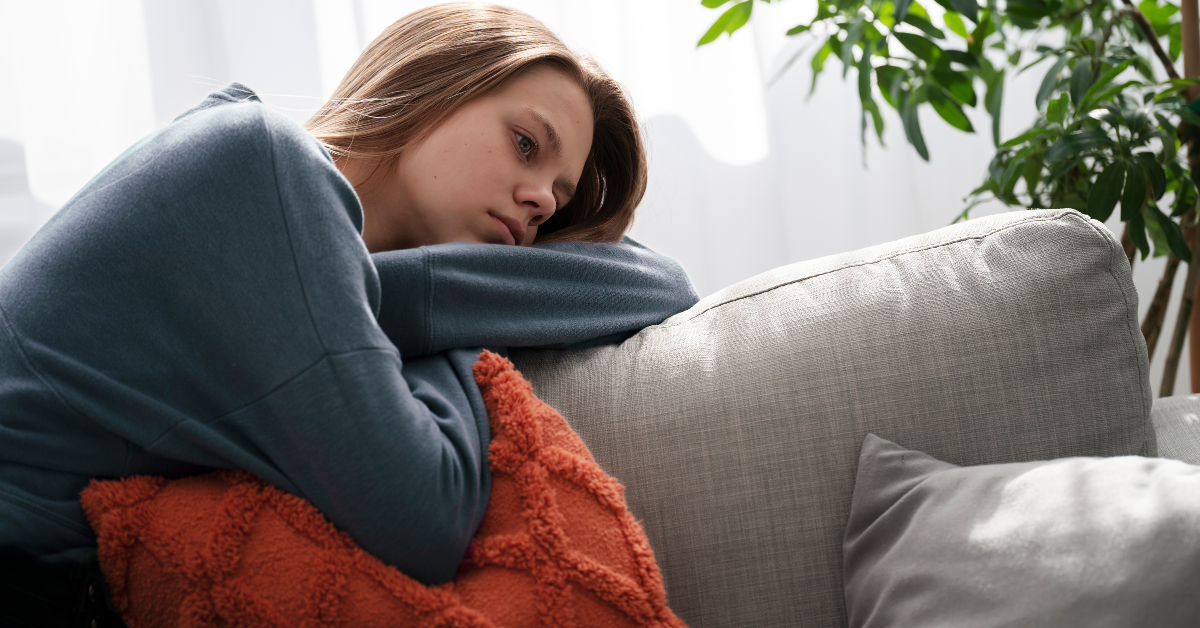devojka tužna na kauču